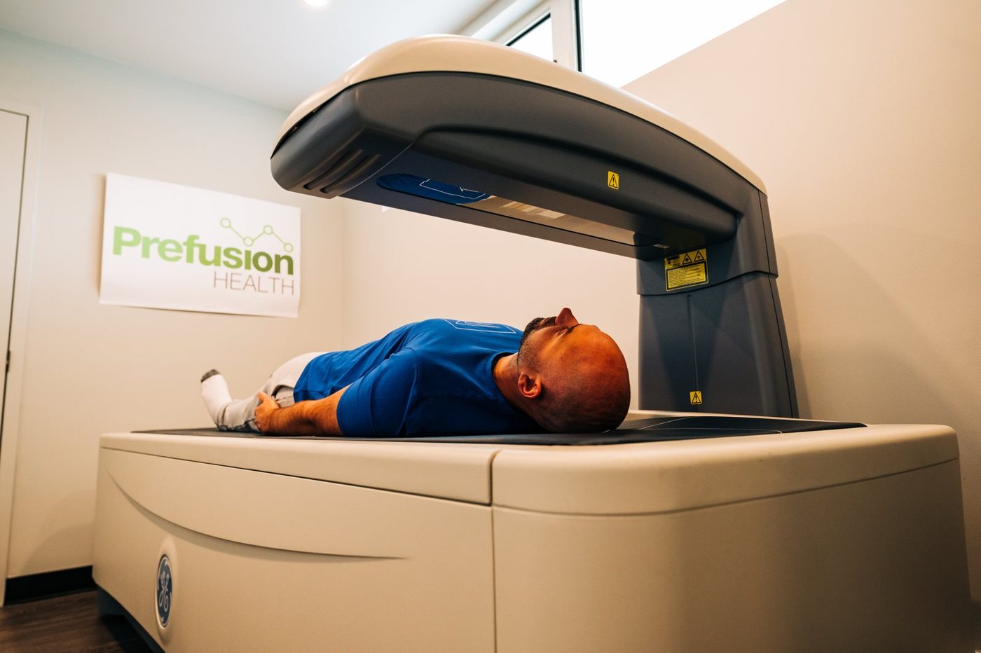 A client lying on the GE DEXA scanner